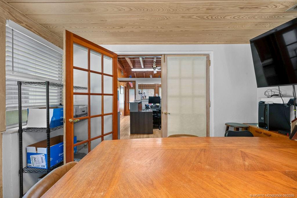 400 Southeast Flamingo Avenue Stuart, FL 34996 - Photo 31 of 33 a bedroom with a bed and a flat screen tv