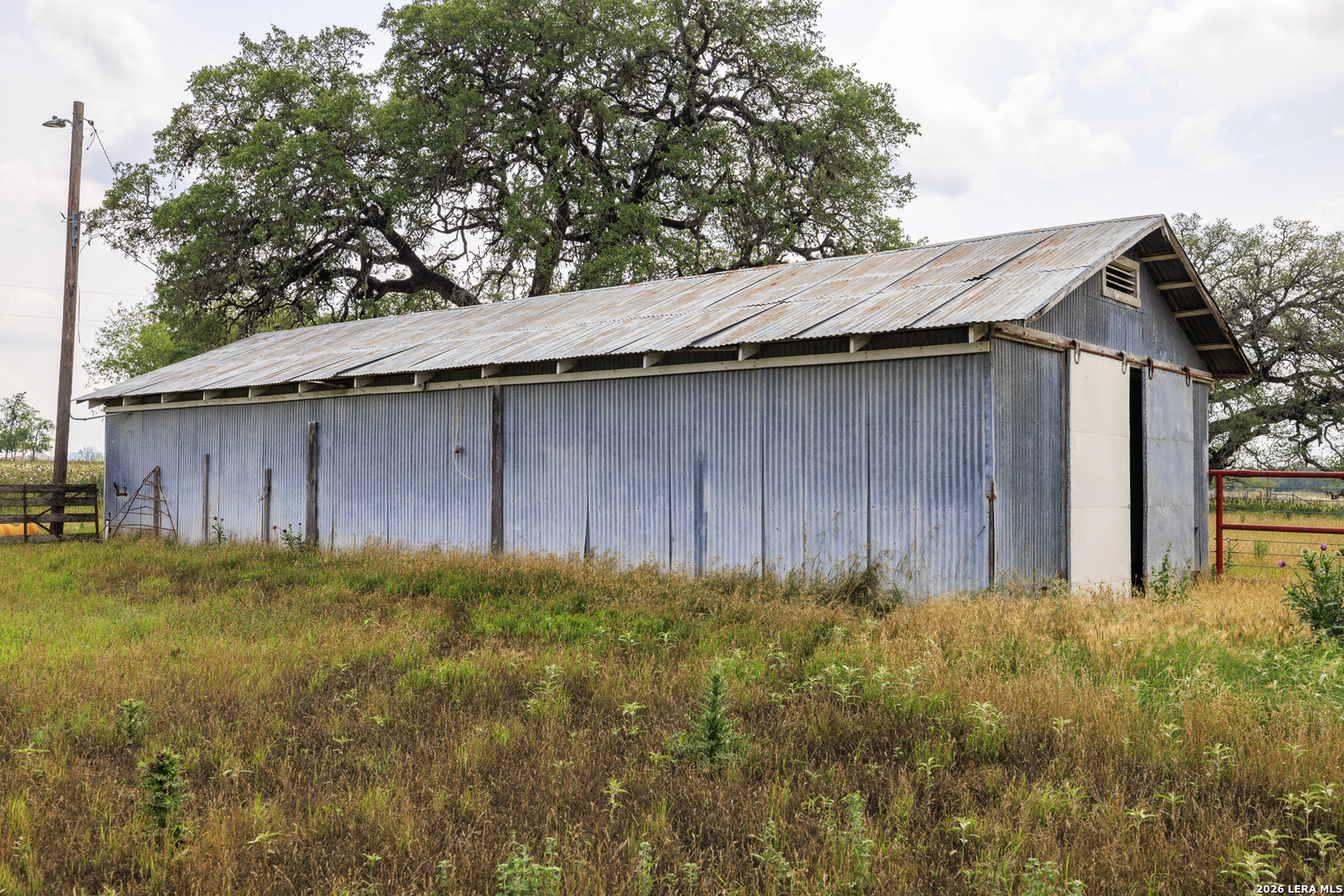 0 Comfort River Ranch Comfort, TX 78013 - Photo 21 of 23 a backyard of a house with large trees and wooden fence