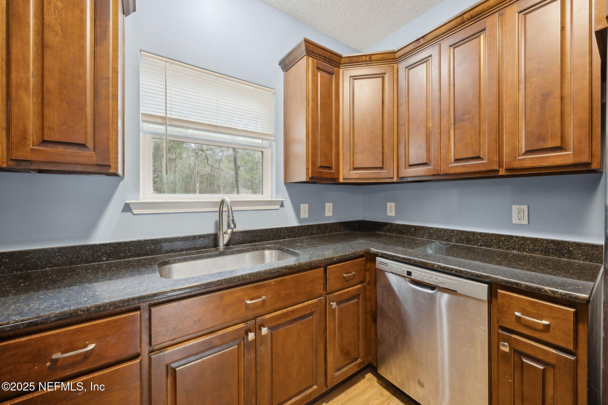 85484 Miner Road Yulee, FL 32097 - Photo 18 of 38 a kitchen with granite countertop cabinets sink and window