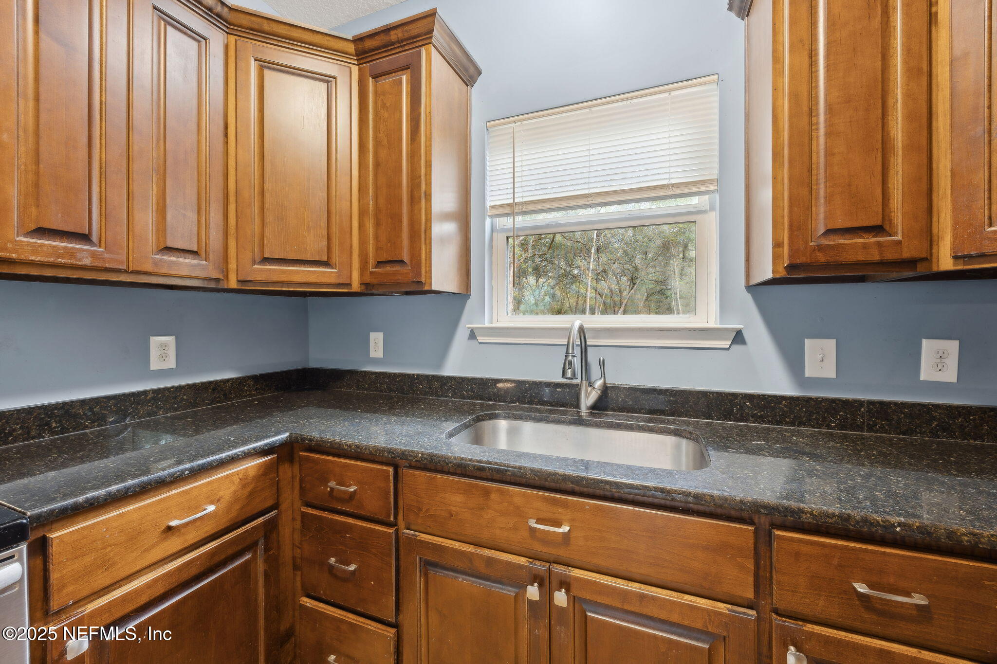 85484 Miner Road Yulee, FL 32097 - Photo 20 of 38 a kitchen with granite countertop cabinets and window