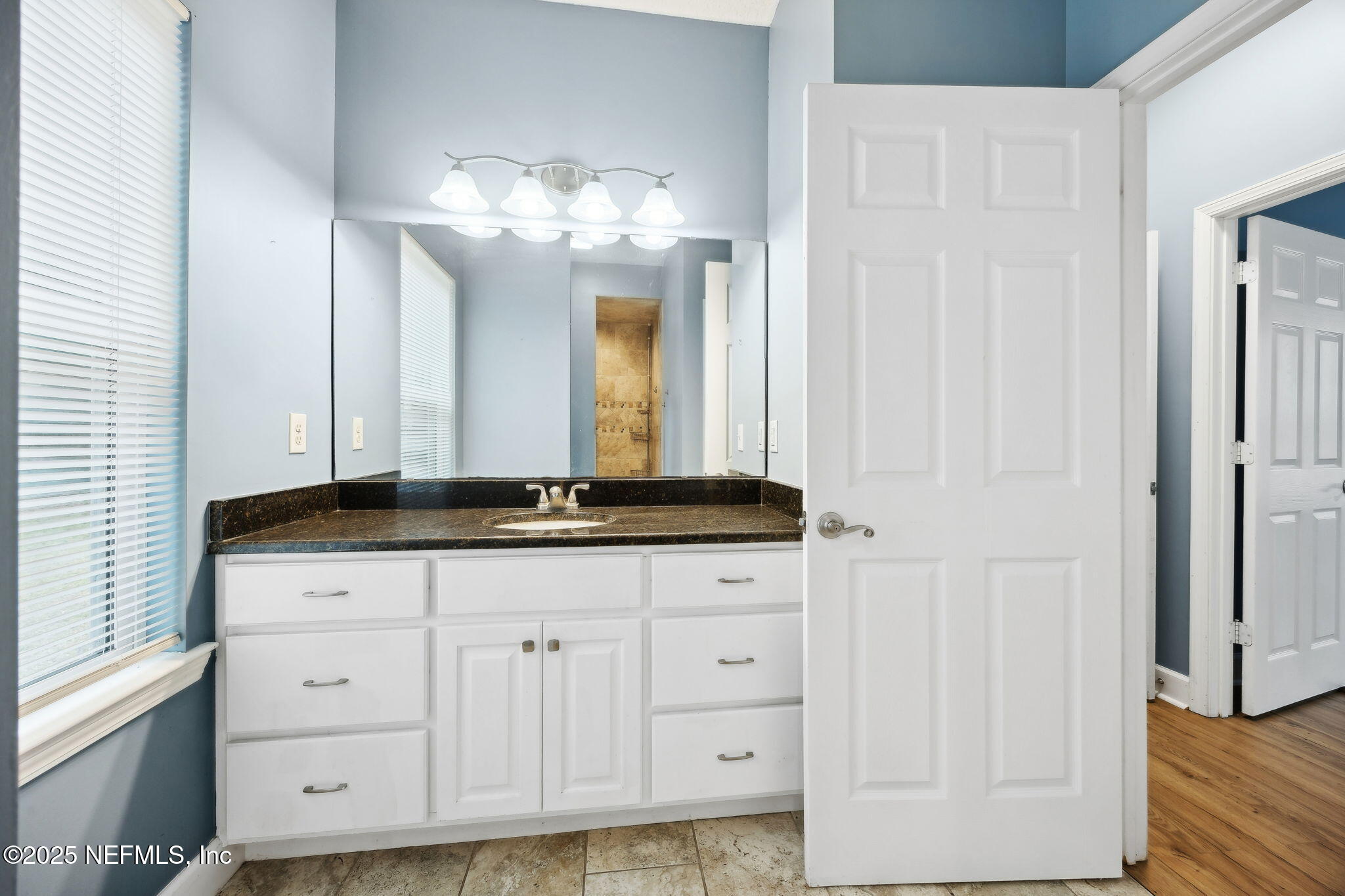 85484 Miner Road Yulee, FL 32097 - Photo 25 of 38 a bathroom with a sink and a mirror