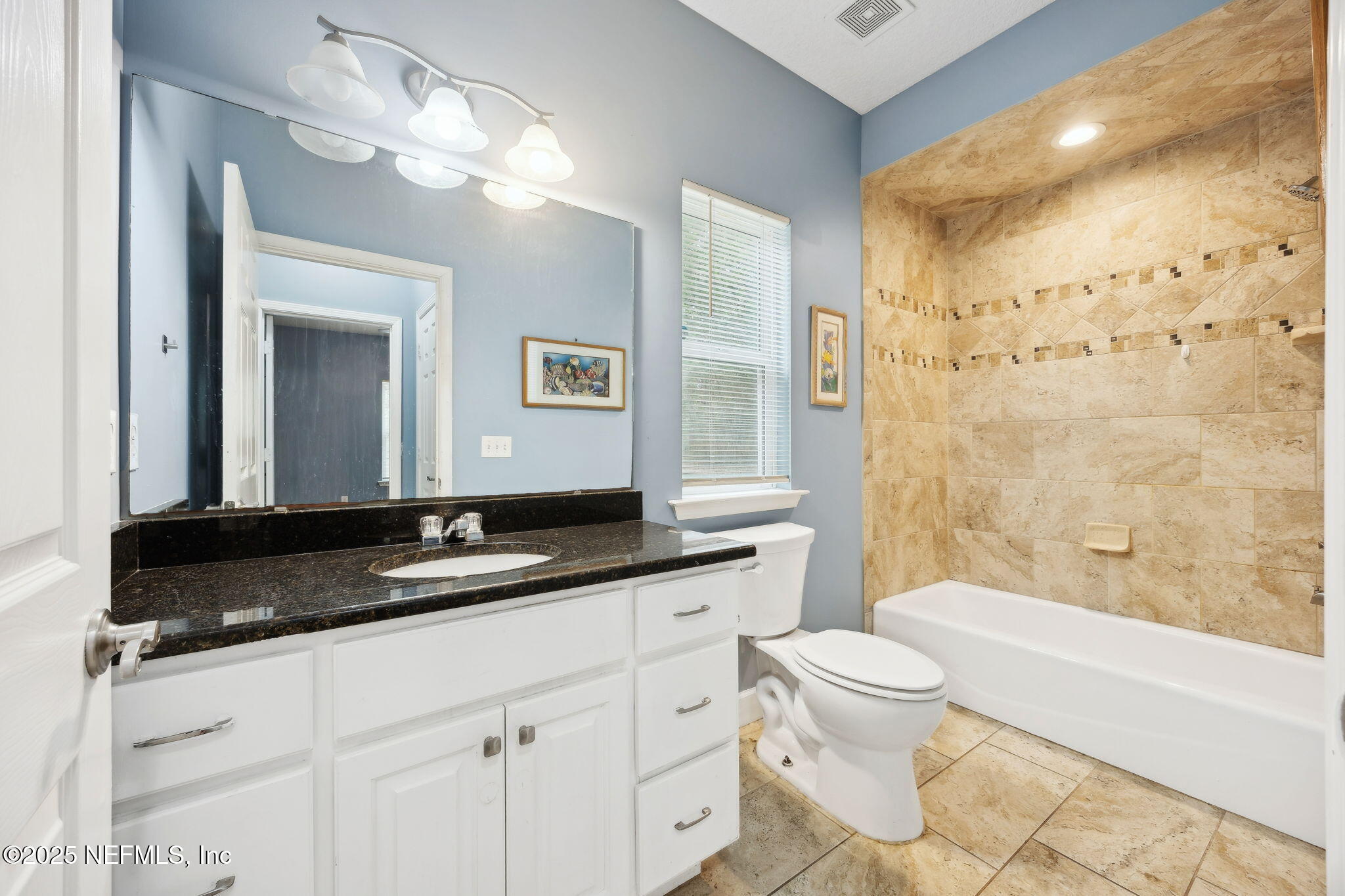 85484 Miner Road Yulee, FL 32097 - Photo 30 of 38 a bathroom with a granite countertop sink a toilet a mirror a vanity and bathtub