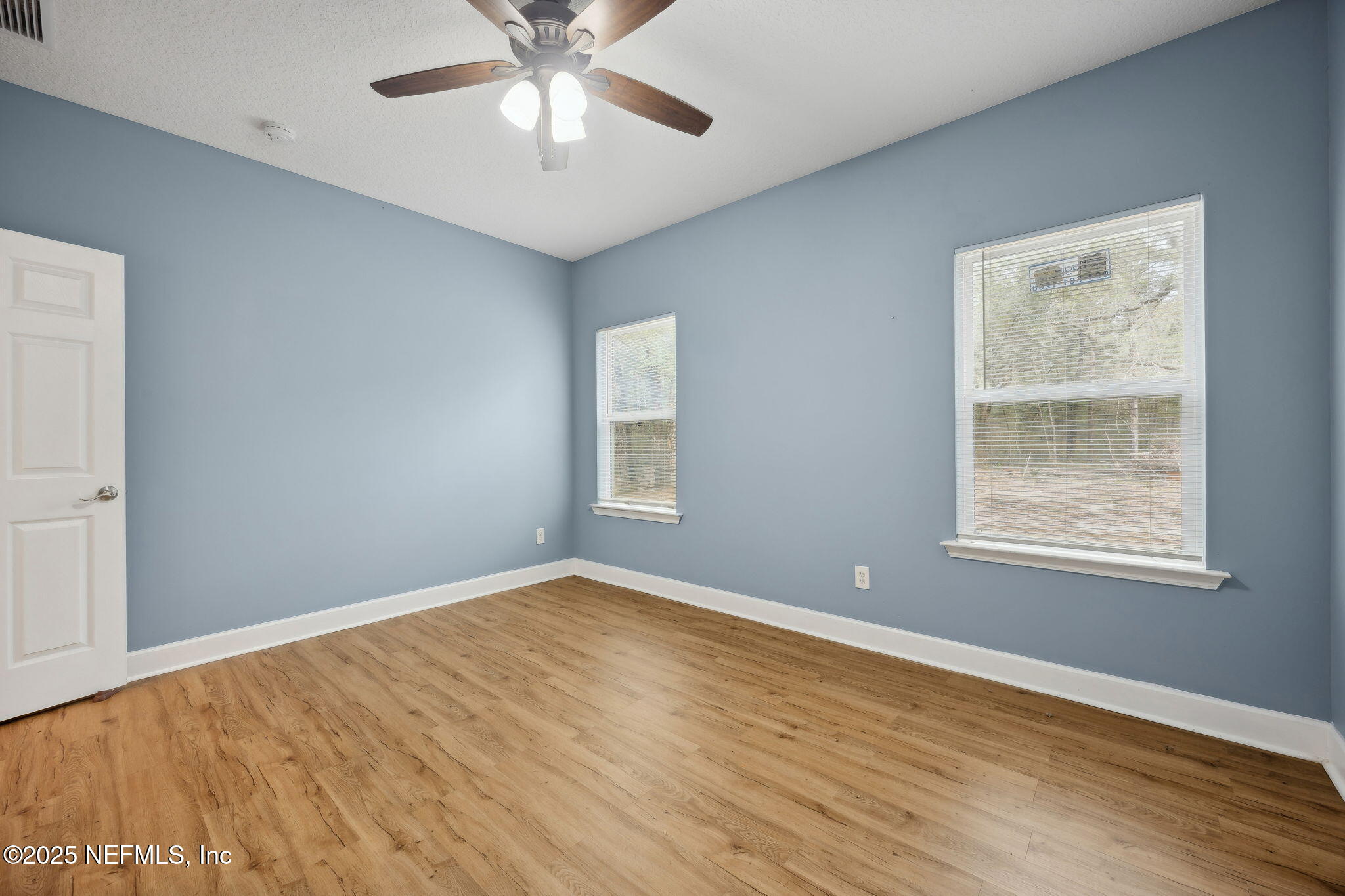 85484 Miner Road Yulee, FL 32097 - Photo 32 of 38 a view of an empty room with wooden floor and a window