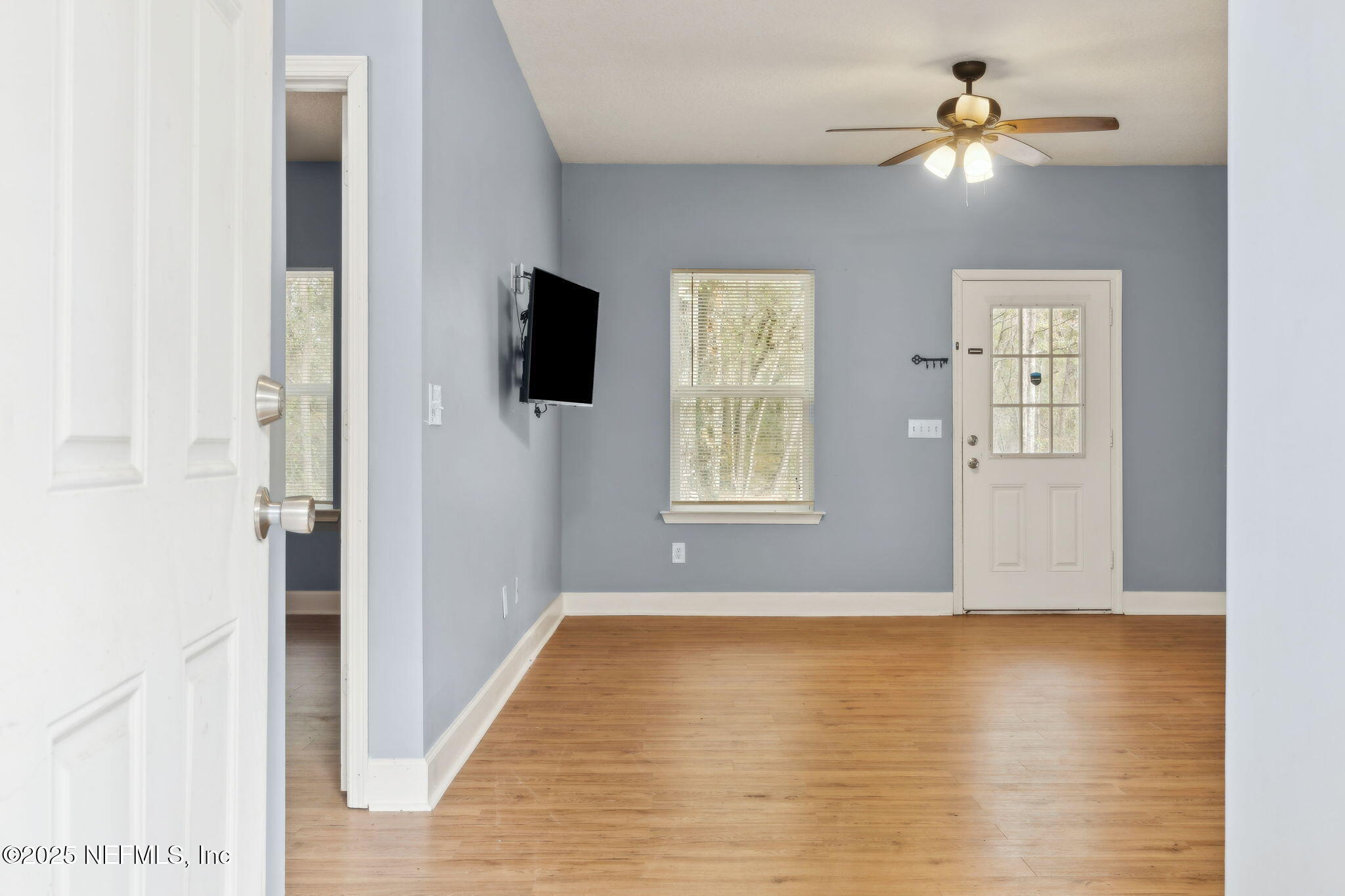 85484 Miner Road Yulee, FL 32097 - Photo 5 of 38 a view of livingroom with hardwood floor and a ceiling fan