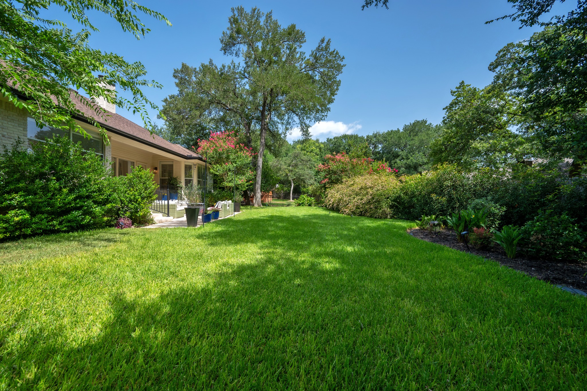 30115 Sawgrass Trail Georgetown, TX 78628 - Photo 27 of 37 A sprawling green lawn and mature trees frame this charming residence, perfect for outdoor living.