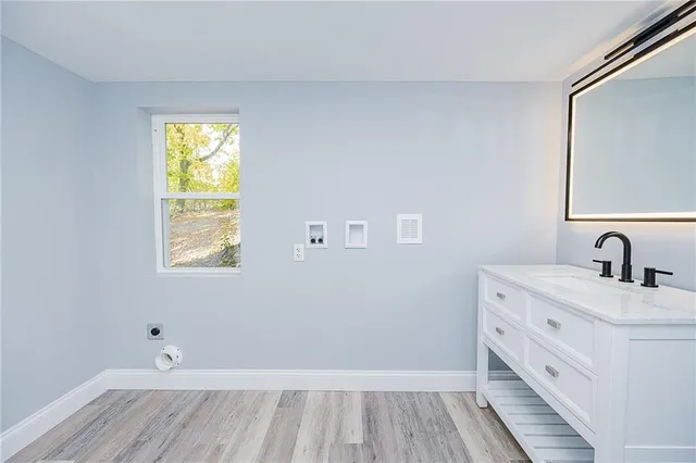 a bathroom with a sink and a window