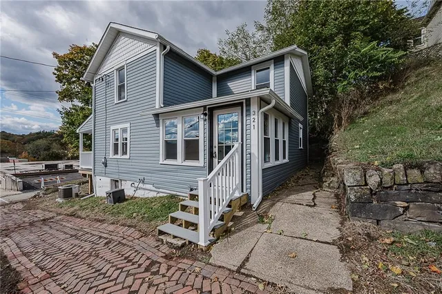 a front view of a house with garden