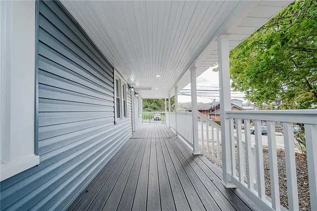 a view of balcony with wooden floor