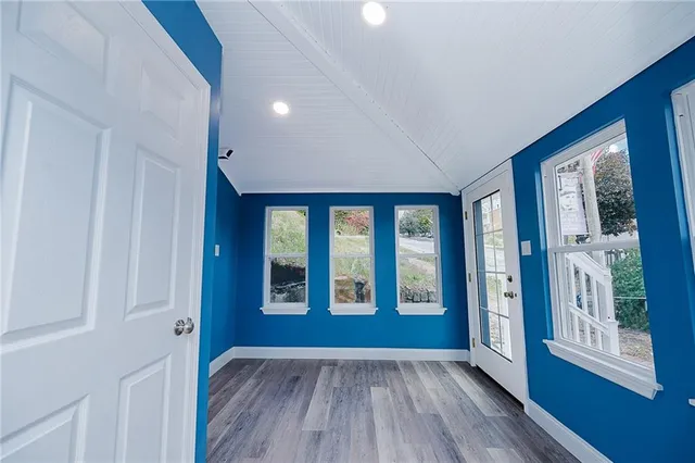 a view of an entryway with wooden floor and windows