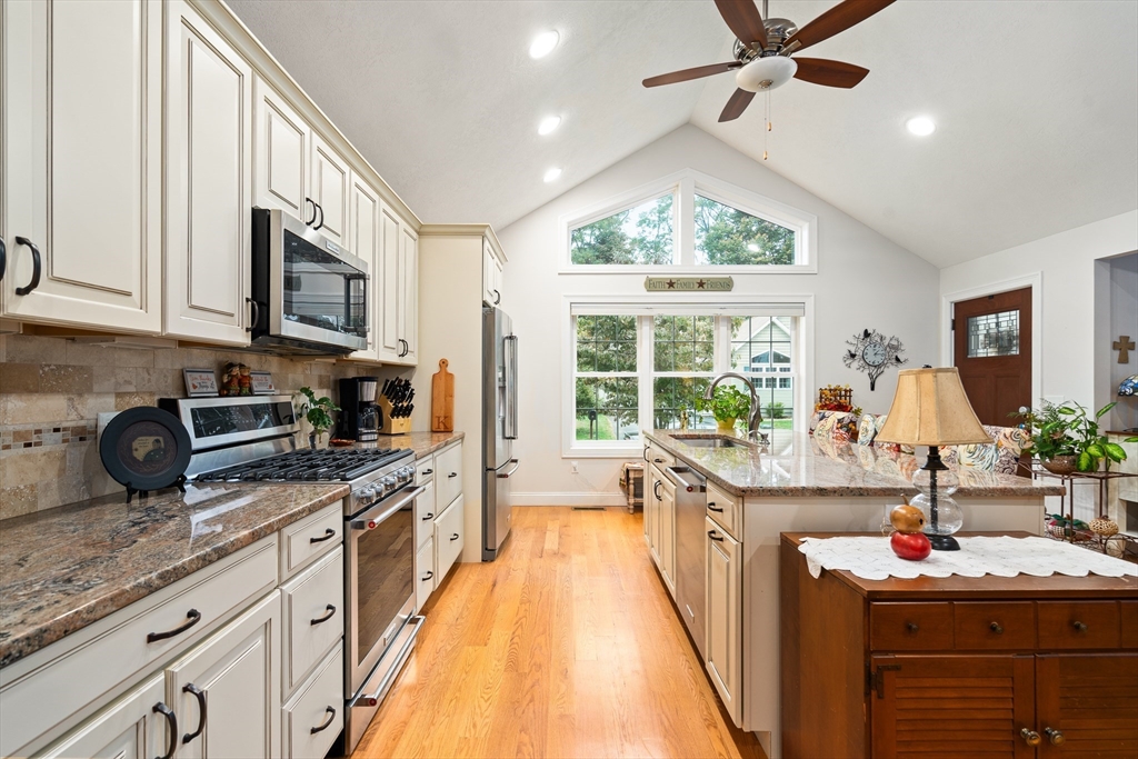 25 Paul Street Easthampton, MA 01027 - Photo 14 of 42 a kitchen with kitchen island granite countertop a sink appliances cabinets and a large window