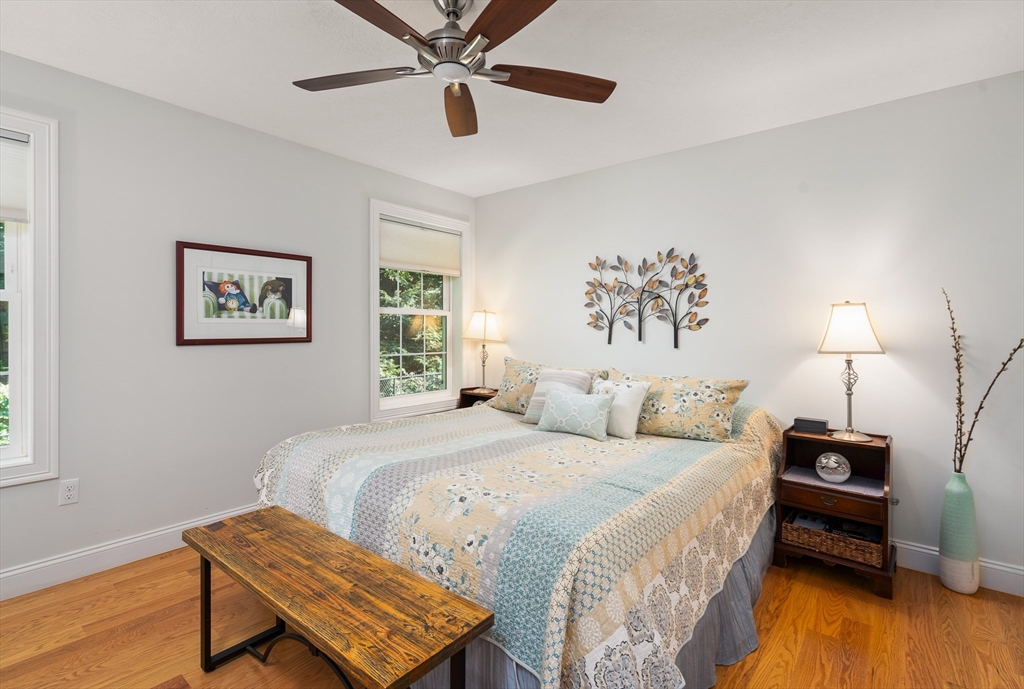 25 Paul Street Easthampton, MA 01027 - Photo 23 of 42 a bedroom with a bed and a lamp on dresser with wooden floor