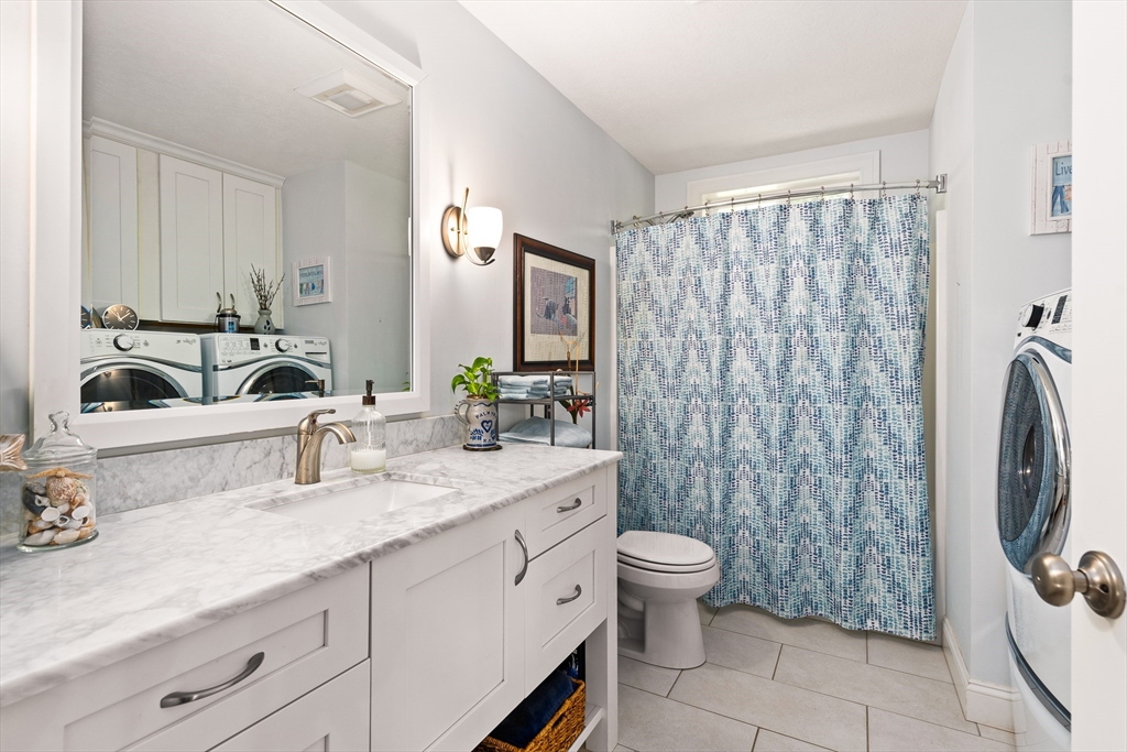 25 Paul Street Easthampton, MA 01027 - Photo 35 of 42 a bathroom with a double vanity sink mirror and toilet