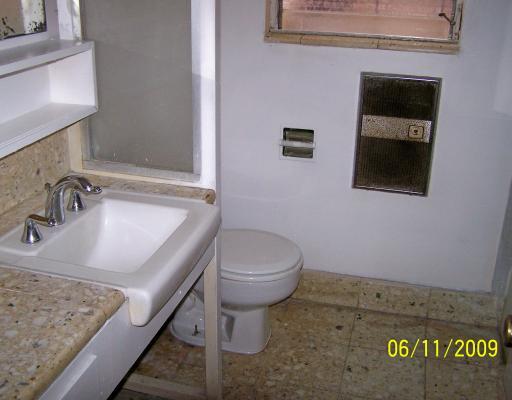 4609 Gollihar Road, Unit 1 Corpus Christi, TX 78411 - Photo 7 of 10 a bathroom with a granite countertop sink and a mirror