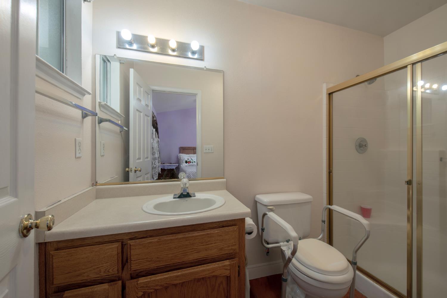 728 9th Street Sanger, CA 93657 - Photo 12 of 24 a bathroom with a sink toilet and shower