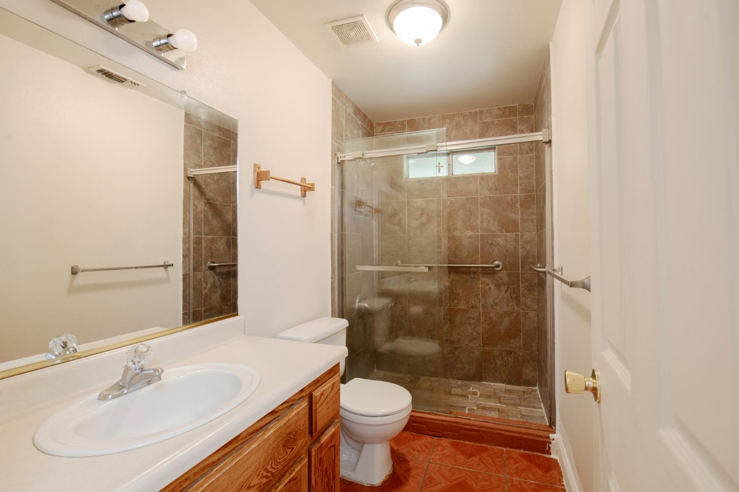 728 9th Street Sanger, CA 93657 - Photo 13 of 24 a bathroom with a sink toilet and shower