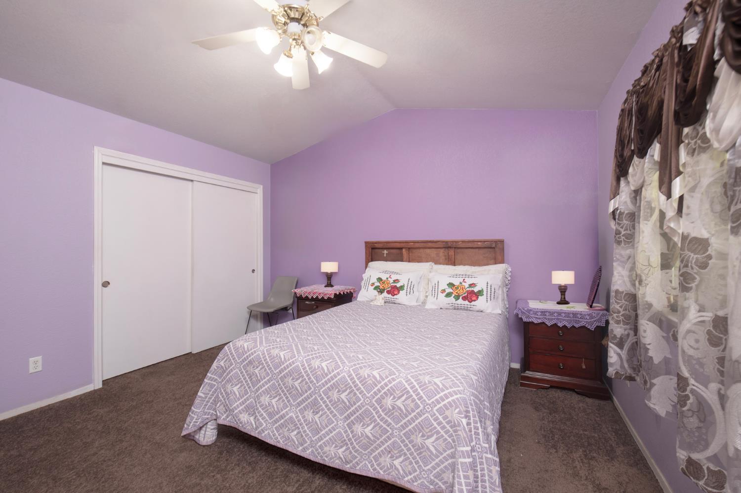 728 9th Street Sanger, CA 93657 - Photo 14 of 24 a bedroom with a bed and a chandelier