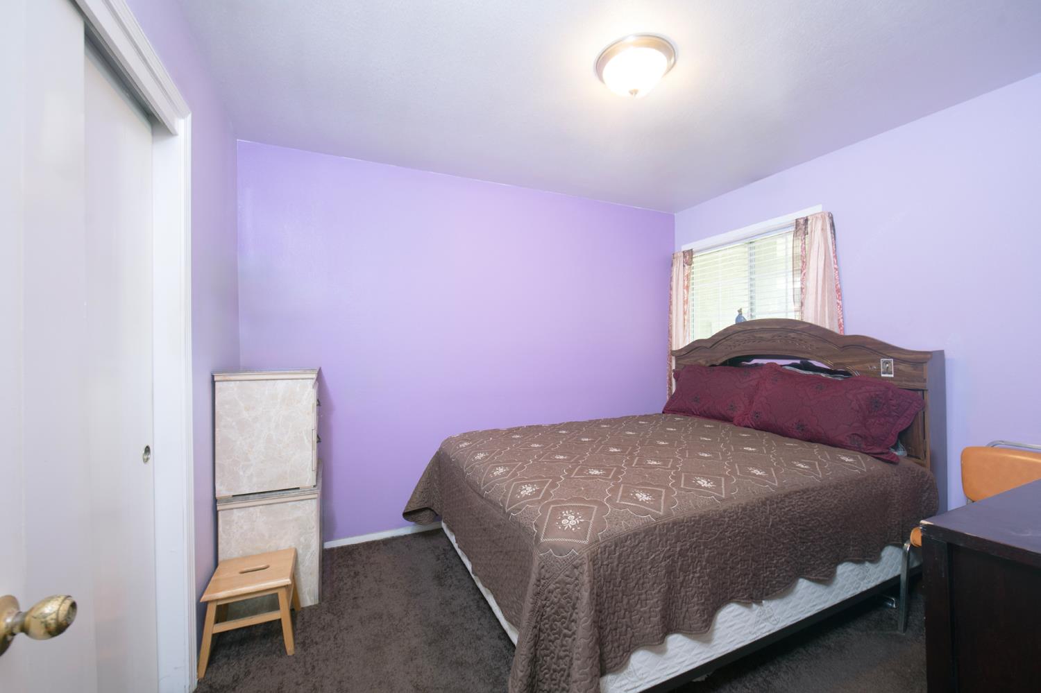 728 9th Street Sanger, CA 93657 - Photo 15 of 24 a bedroom with a bed and a window