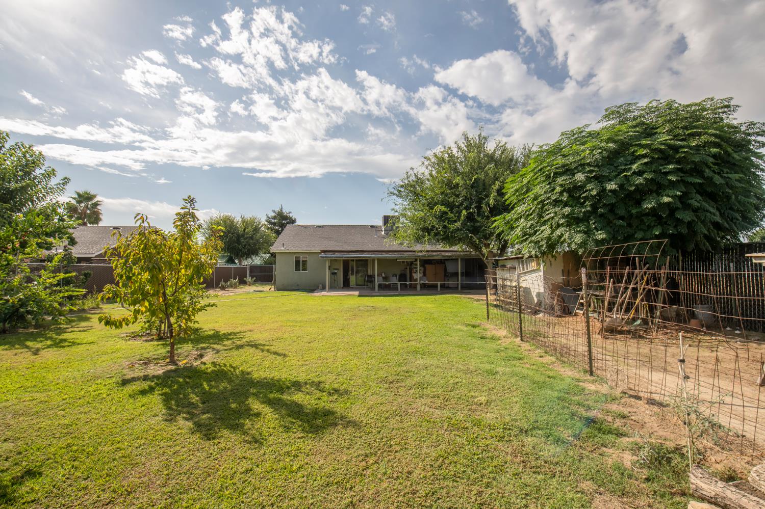 728 9th Street Sanger, CA 93657 - Photo 18 of 24 a swimming pool with trees in the background