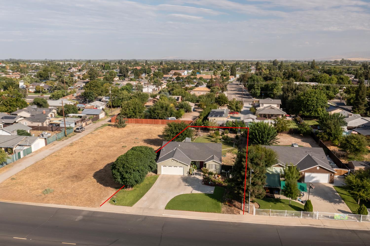 728 9th Street Sanger, CA 93657 - Photo 20 of 24 an aerial view of residential houses with outdoor space