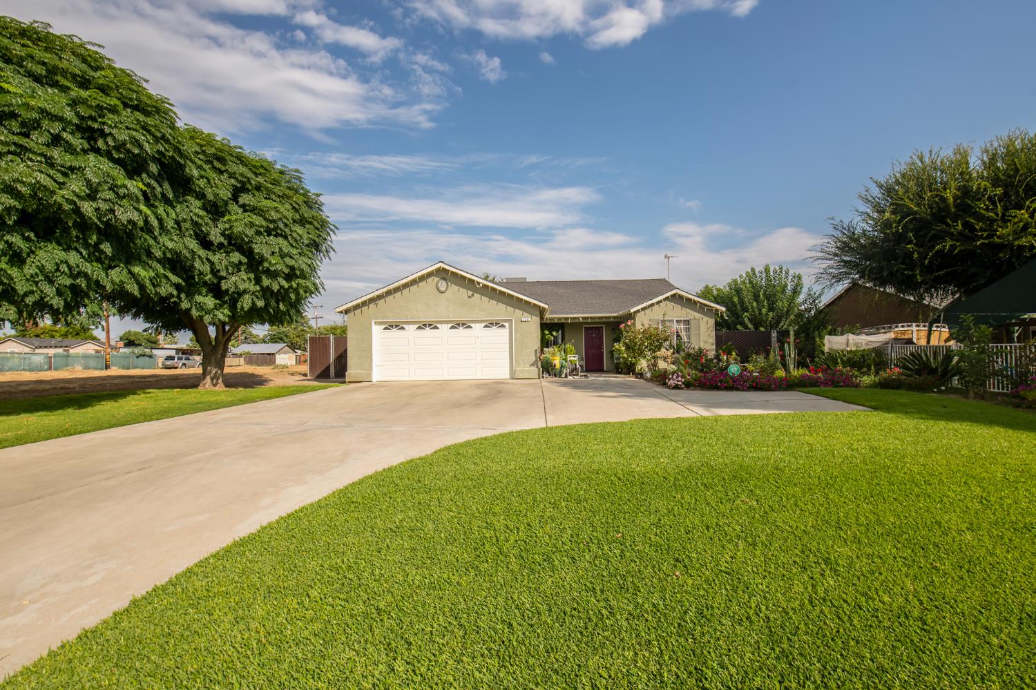 728 9th Street Sanger, CA 93657 - Photo 4 of 24 a view of green field with house in the background