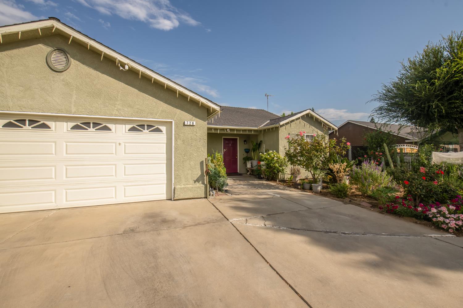728 9th Street Sanger, CA 93657 - Photo 6 of 24 a view of a house with a garage
