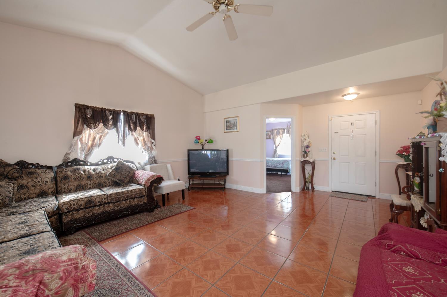 728 9th Street Sanger, CA 93657 - Photo 9 of 24 a living room with furniture and a flat screen tv