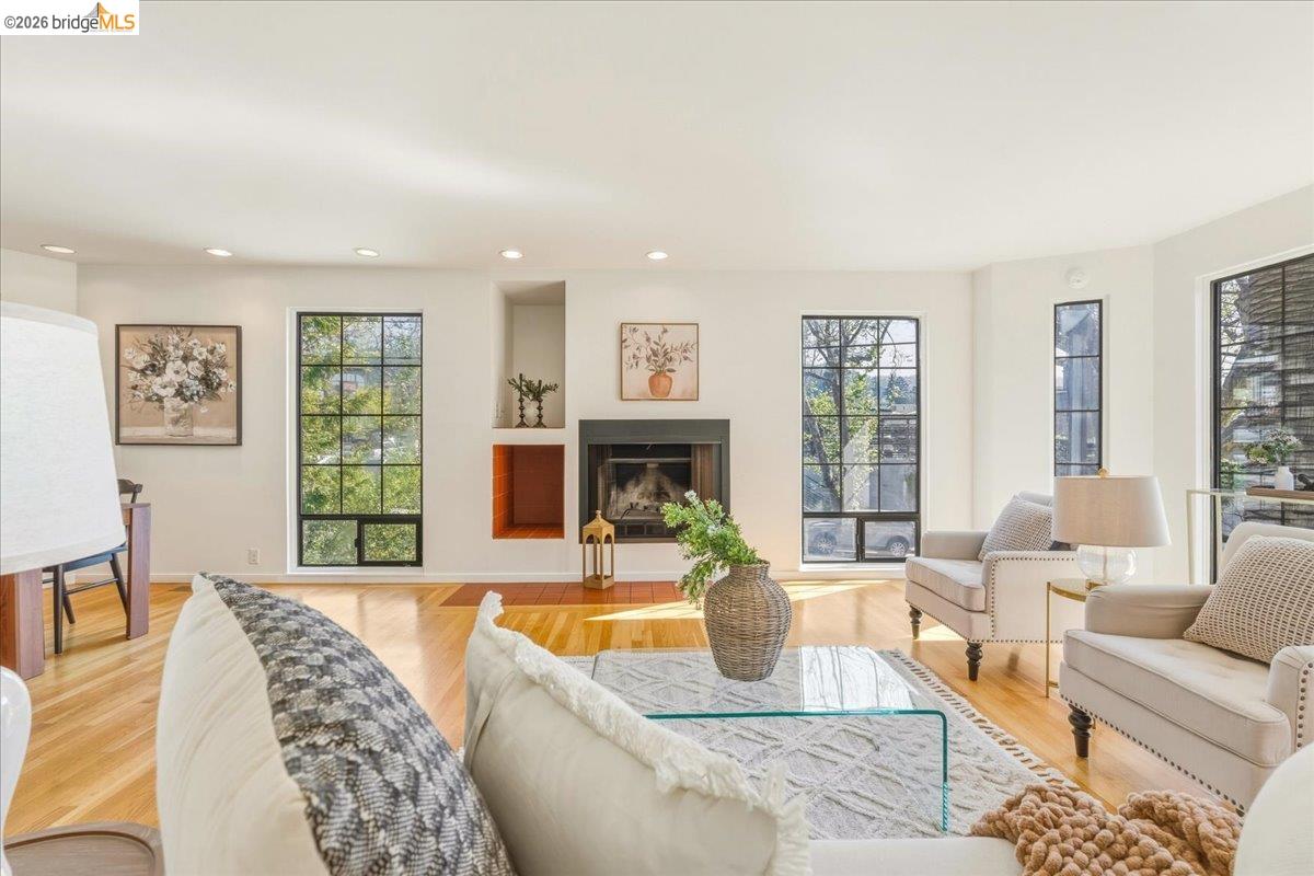 1408 Henry Street Berkeley, CA 94709 - Photo 3 of 28 Living room with light wood-style flooring, a fireplace with raised hearth, and recessed lighting