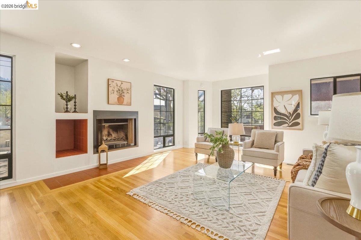 1408 Henry Street Berkeley, CA 94709 - Photo 5 of 28 Living room with light wood-style floors, a fireplace, and recessed lighting