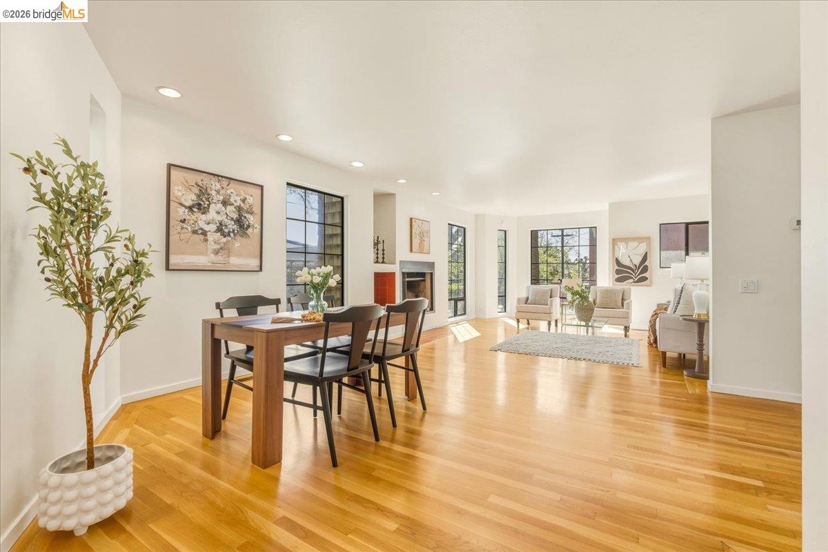 1408 Henry Street Berkeley, CA 94709 - Photo 9 of 28 Dining area with light wood-type flooring, recessed lighting, and a fireplace