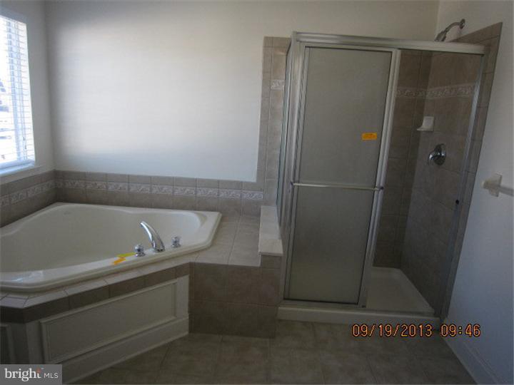 22 Bryce Road Berlin, NJ 08009 - Photo 12 of 17 a bathroom with a bathtub and a shower