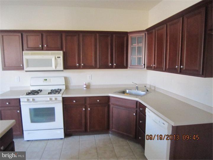 22 Bryce Road Berlin, NJ 08009 - Photo 6 of 17 a kitchen with stainless steel appliances granite countertop wooden cabinets a sink and dishwasher