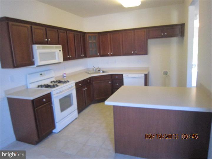 22 Bryce Road Berlin, NJ 08009 - Photo 7 of 17 a kitchen with a sink a stove and cabinets