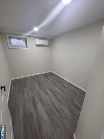 a spacious bathroom with a tub sink and mirror