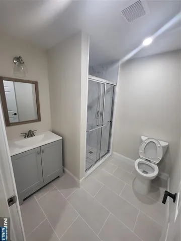 a bed sitting in a spacious bedroom next to a window