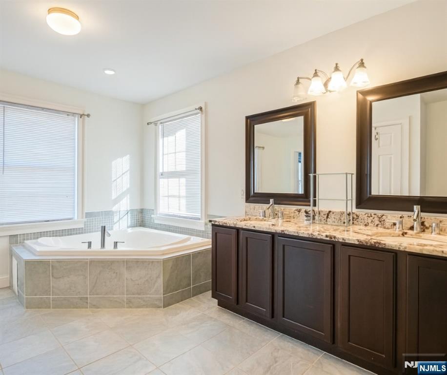 457 Elm Street Stirling, NJ 07980 - Photo 19 of 25 a spacious bathroom with a tub sink and mirror