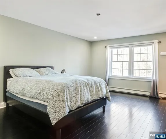 an empty room with wooden floor and white walls