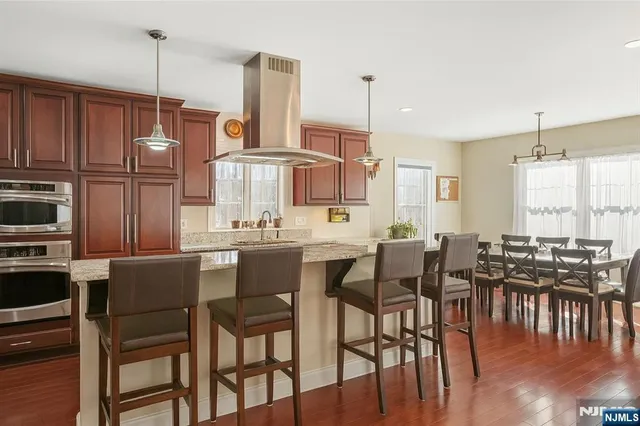 a bathroom with a tub sink shower and mirror