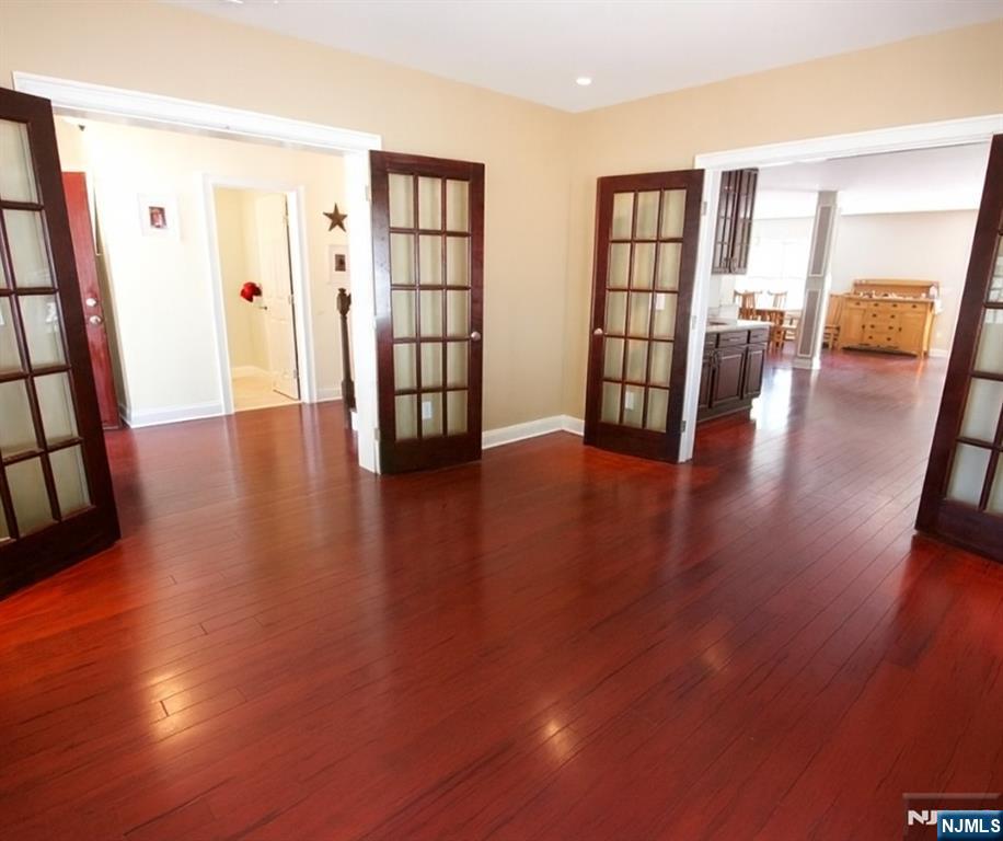 457 Elm Street Stirling, NJ 07980 - Photo 9 of 25 an empty room with wooden floor and windows