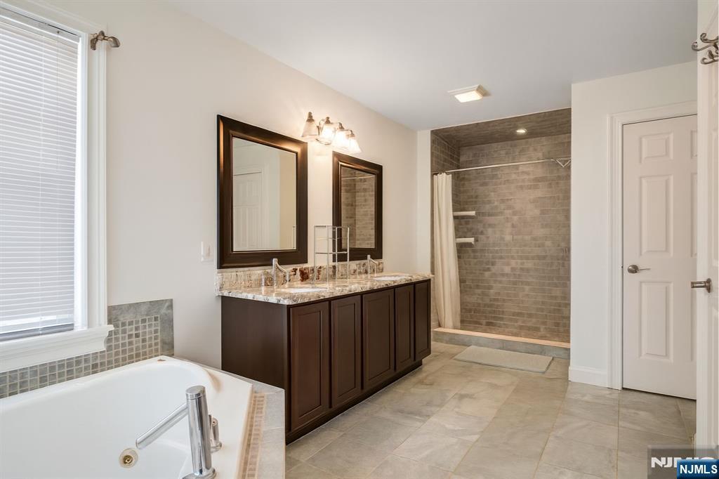 457 Elm Street Stirling, NJ 07980 - Photo 10 of 25 a bathroom with a tub sink shower and mirror