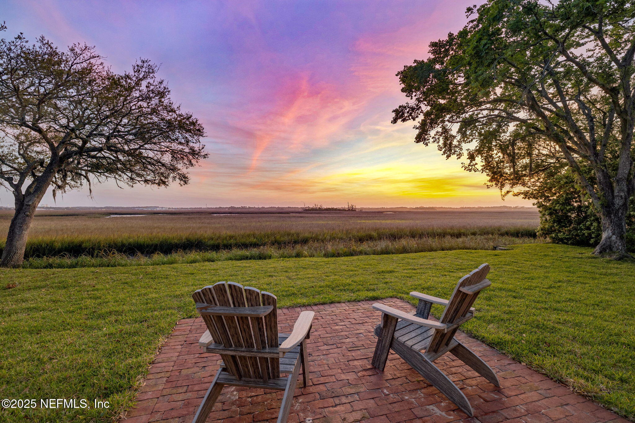 83 Tallwood Road Jacksonville Beach, FL 32250 - Photo 50 of 66 a view of a lake with table and chairs under an umbrella