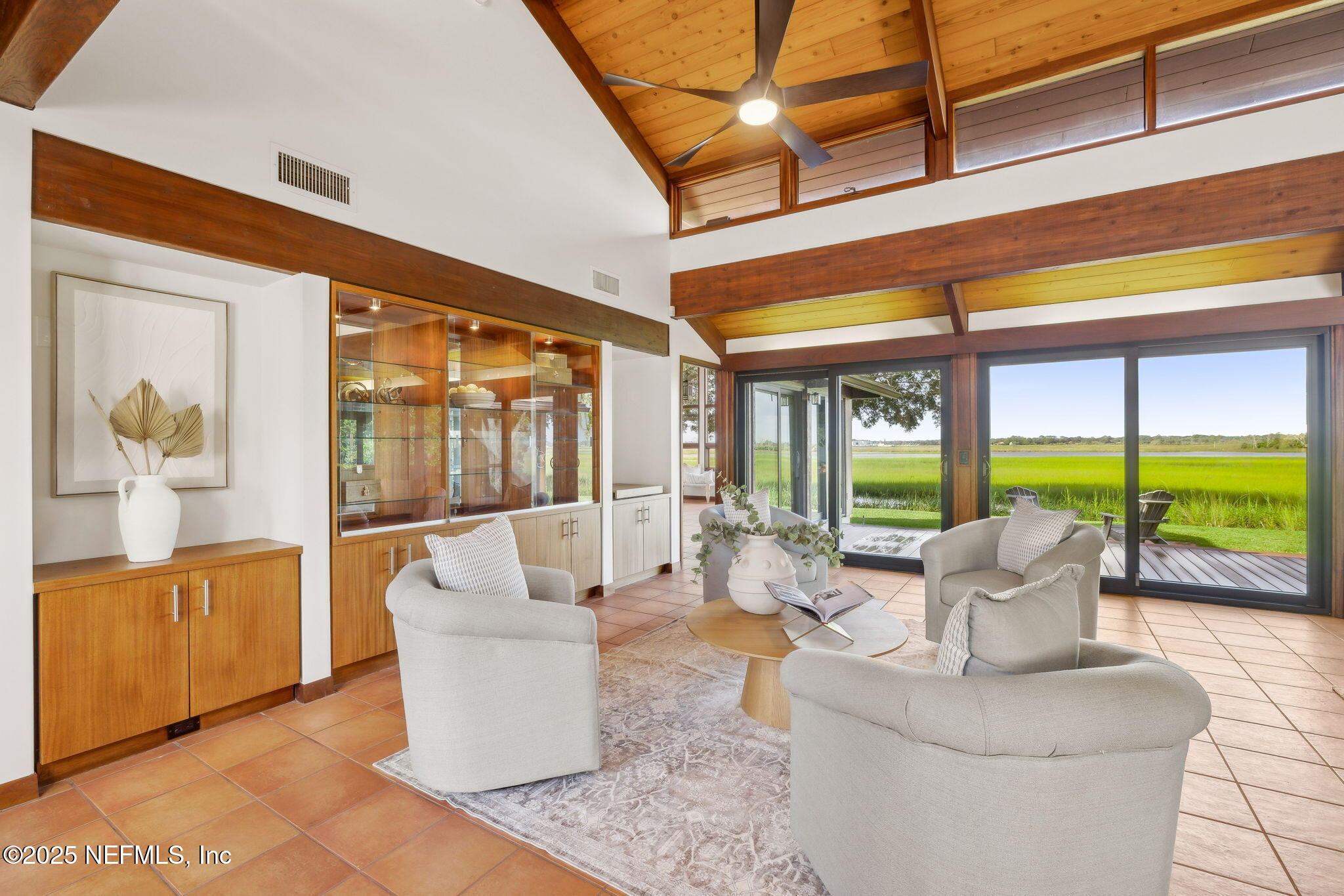 83 Tallwood Road Jacksonville Beach, FL 32250 - Photo 9 of 66 a living room with furniture and floor to ceiling windows