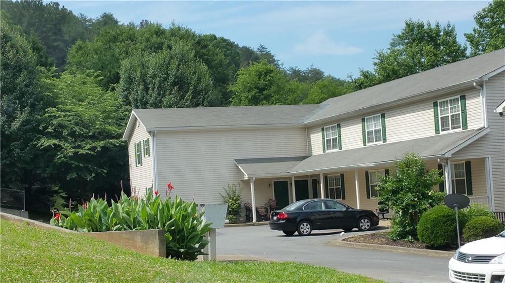 a car parked in front of white house