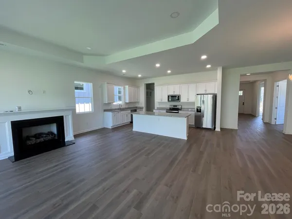 a view of kitchen with livingroom and fireplace