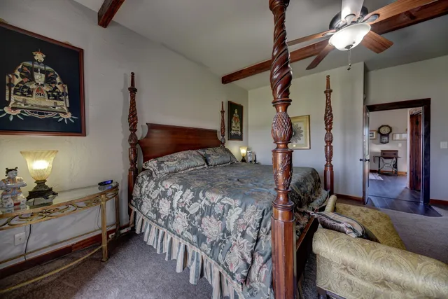 a bedroom with a bed window and a lamp