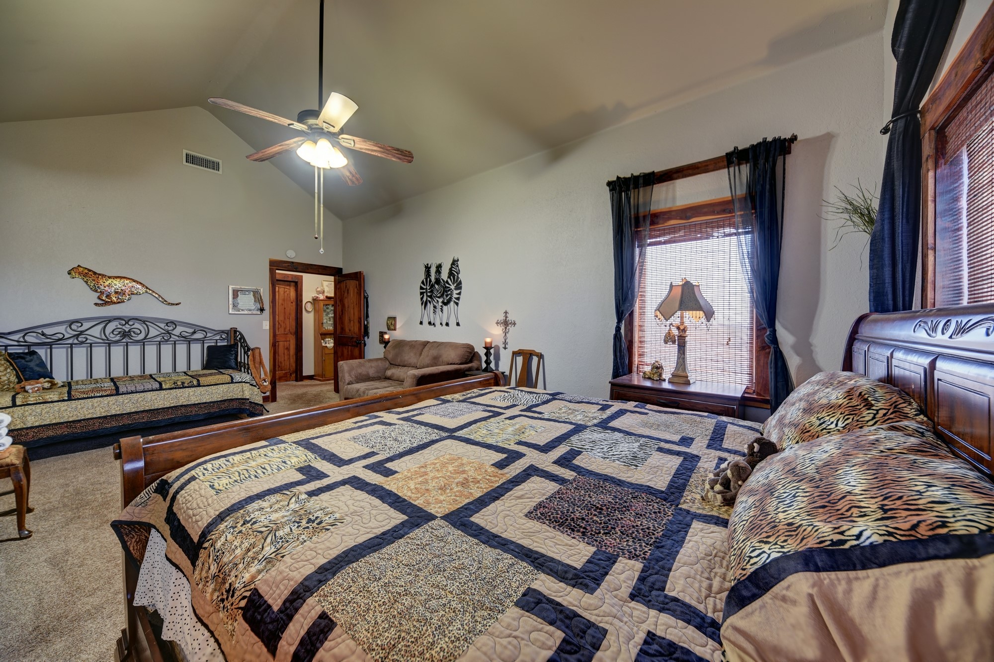 2645 Kallus Road La Grange, TX 78945 - Photo 17 of 25 a bedroom with a bed and a chandelier