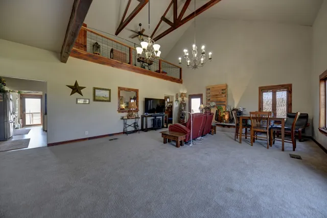 a living room with furniture and a chandelier