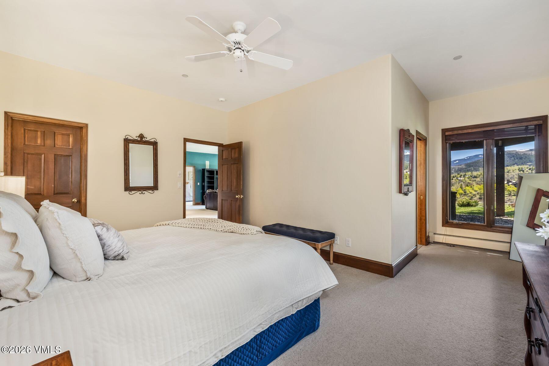 167 Saddle Ridge Edwards, CO 81632 - Photo 25 of 41 a bedroom with a large bed and a chandelier