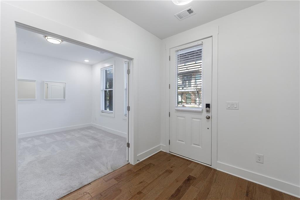 1032 Robert Smalls Way Atlanta, GA 30318 - Photo 16 of 74 an empty room with wooden floor and windows