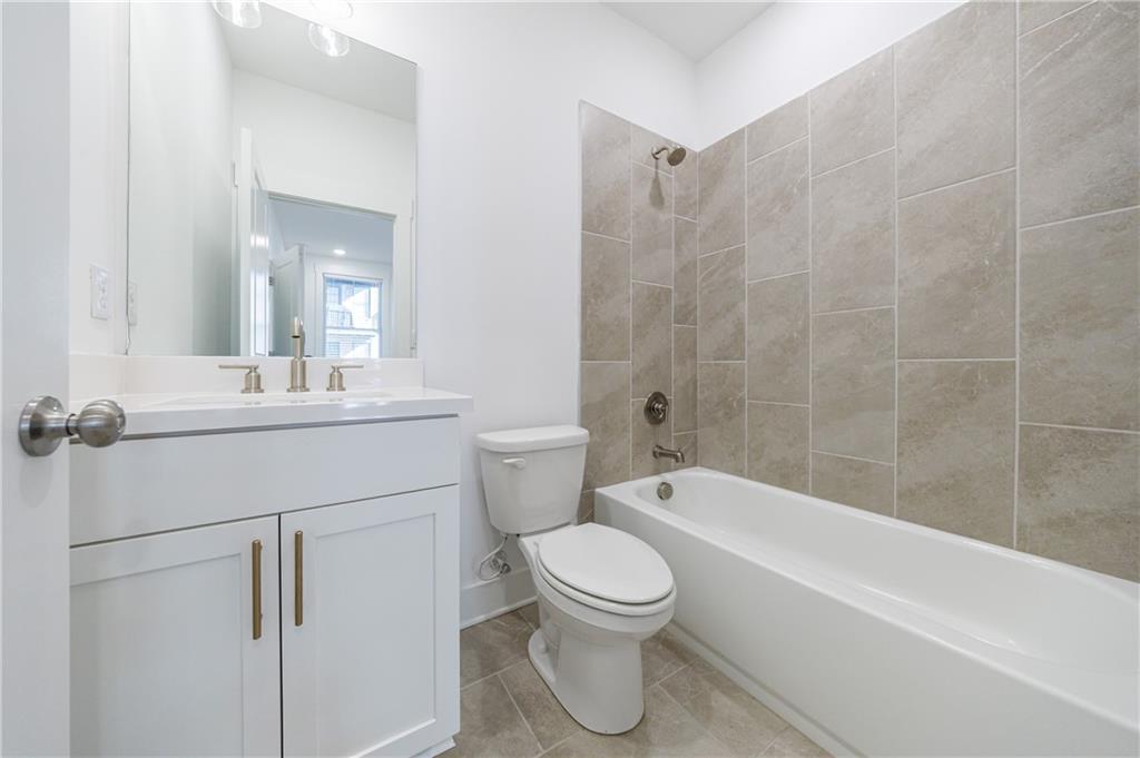 1032 Robert Smalls Way Atlanta, GA 30318 - Photo 19 of 74 a bathroom with a sink toilet and shower