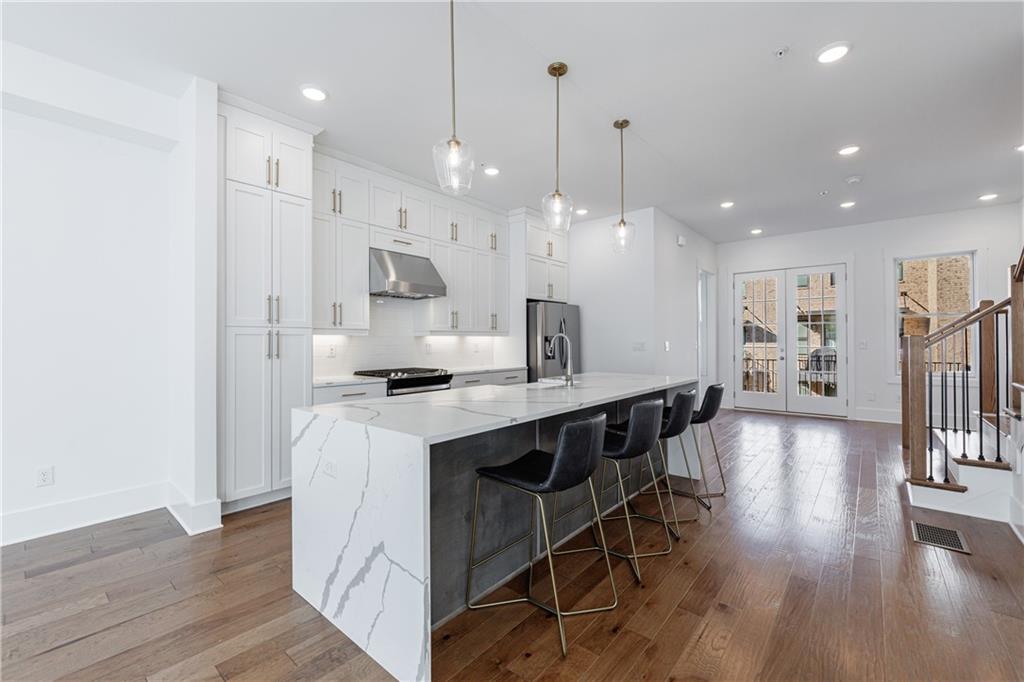 1032 Robert Smalls Way Atlanta, GA 30318 - Photo 23 of 74 a large kitchen with stainless steel appliances kitchen island a large island in the center